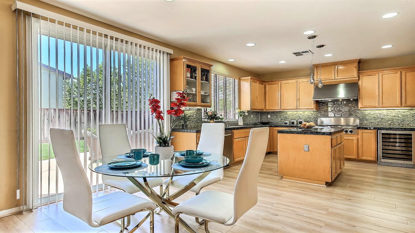 100 Mintaro Court San Ramon, CA 94582 - Photo 9 of 26 a kitchen with stainless steel appliances granite countertop wooden floor and a refrigerator
