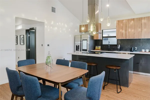 a kitchen with a table and chairs in it