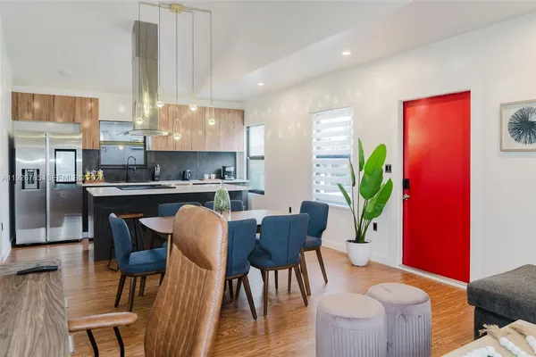 a view of a dining room with furniture and a potted plant