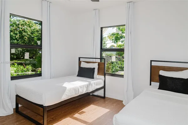 a bedroom with a bed window and a potted plant
