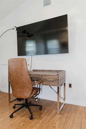 a view of workspace with hardwood wall