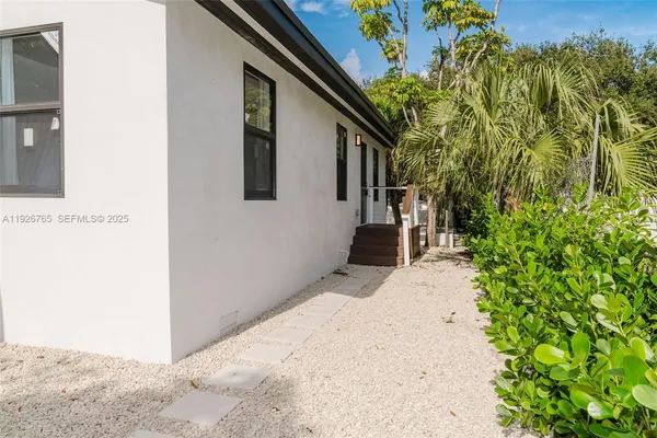 a view of a backyard with wooden floor and fence