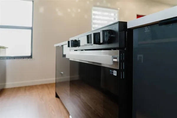 a kitchen with stainless steel appliances a refrigerator and a stove