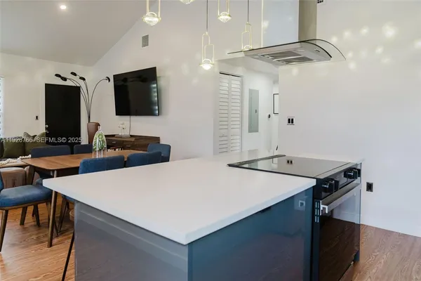 a kitchen with a table chairs refrigerator and microwave