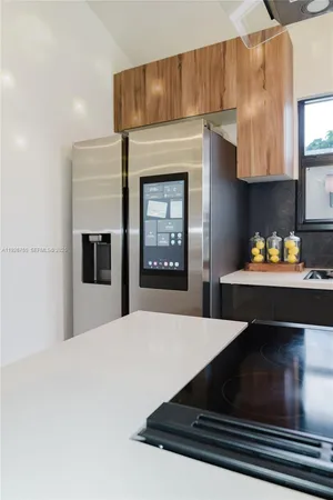 a kitchen view with fireplace and window