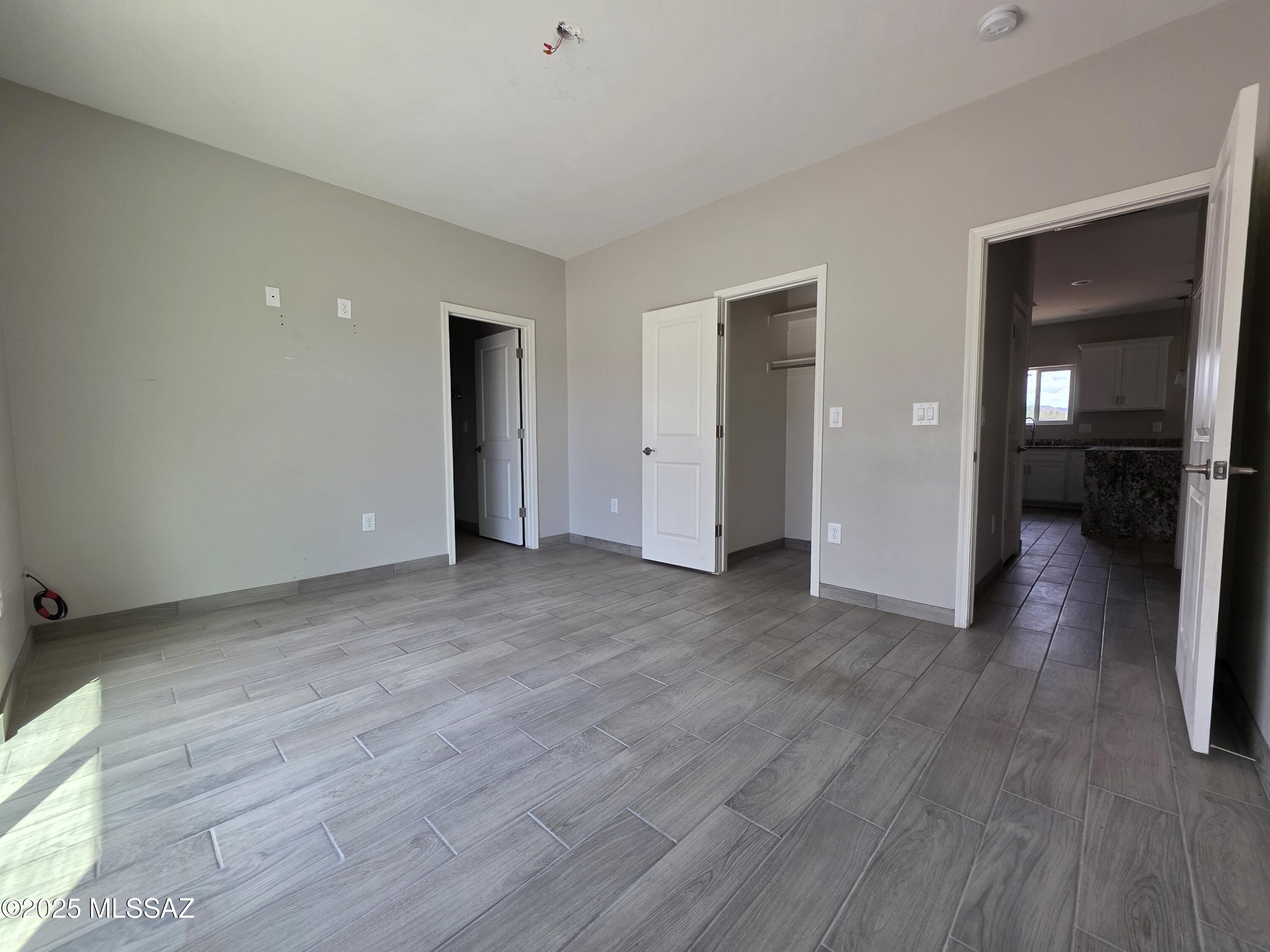 120 Via Venezuela Rio Rico, AZ 85648 - Photo 19 of 37 an empty room with wooden floor and closet