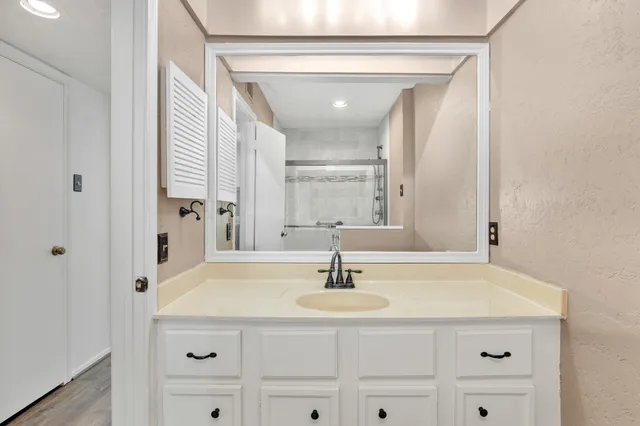 a bathroom with a shower and a sink