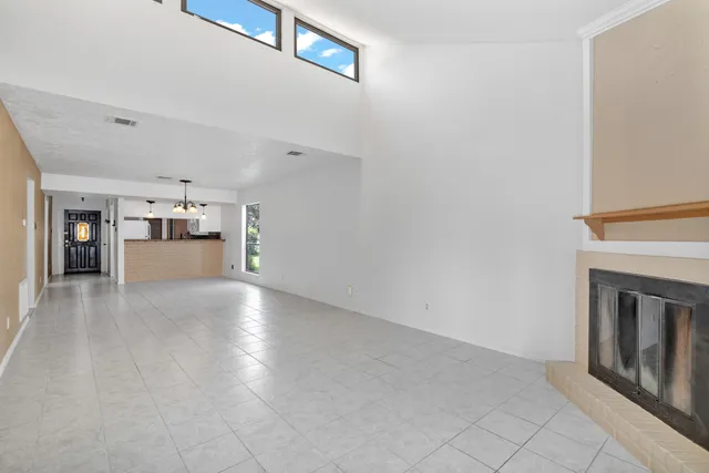 a view of an empty room with a fireplace