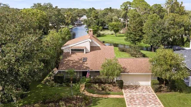 a view of a house with a yard and potted plants