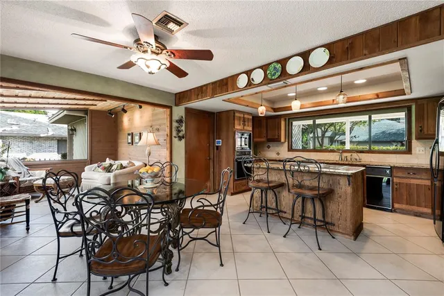 a kitchen that has a stove a table and chairs in it