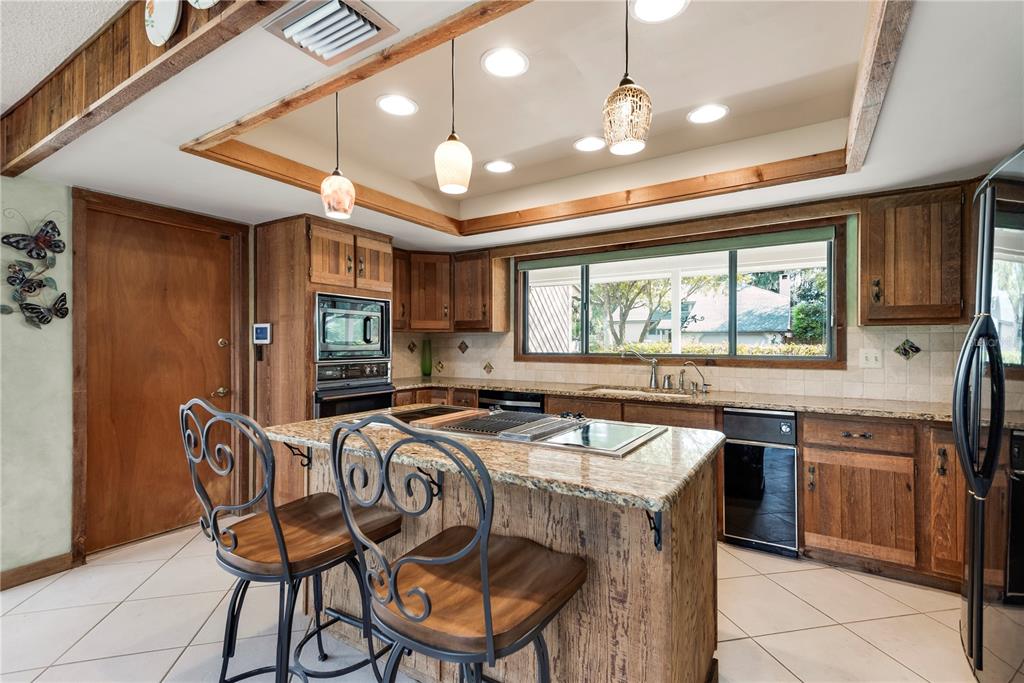 112 1st Street Tavares, FL 32778 - Photo 13 of 38 a kitchen that has a stove a table and chairs in it