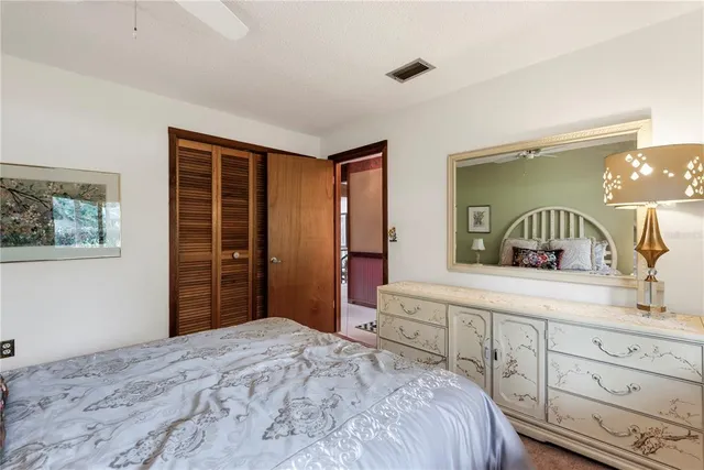 a spacious bedroom with a bed and a large window