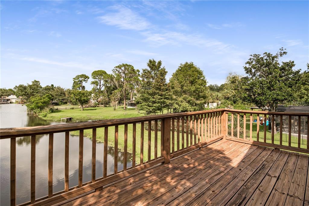 112 1st Street Tavares, FL 32778 - Photo 31 of 38 a balcony with wooden floor and fence