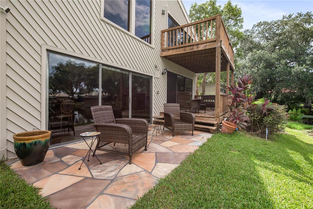 112 1st Street Tavares, FL 32778 - Photo 33 of 38 a view of a patio with table and chairs and potted plants