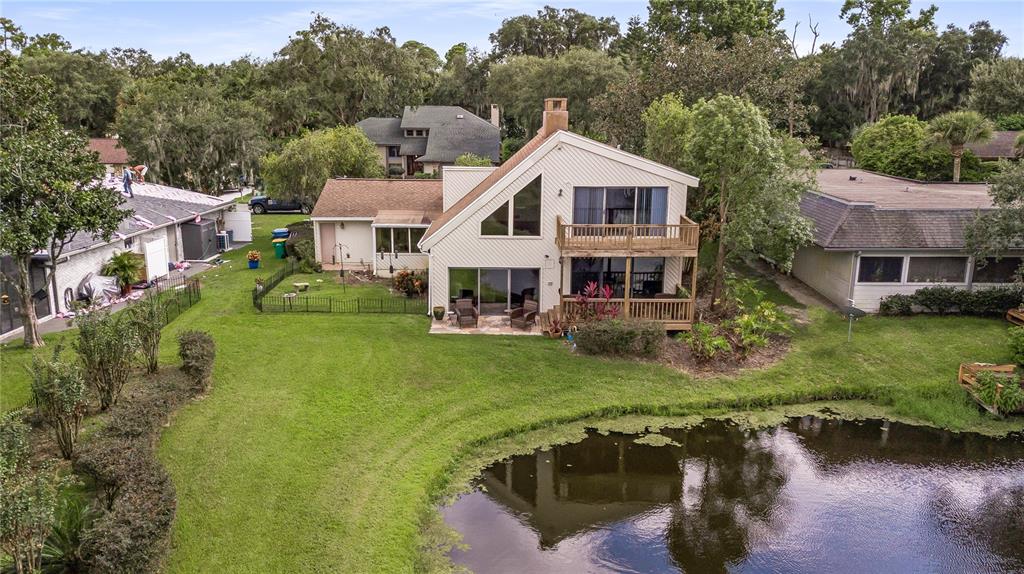 112 1st Street Tavares, FL 32778 - Photo 5 of 38 a aerial view of a house with swimming pool and a yard