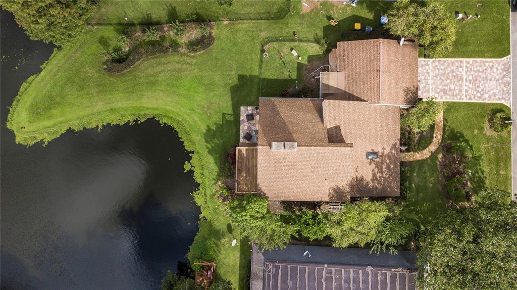 112 1st Street Tavares, FL 32778 - Photo 7 of 38 an aerial view of a house with a yard and garden