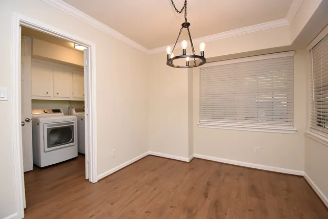 a view of a kitchen with a stove wooden floor and a window