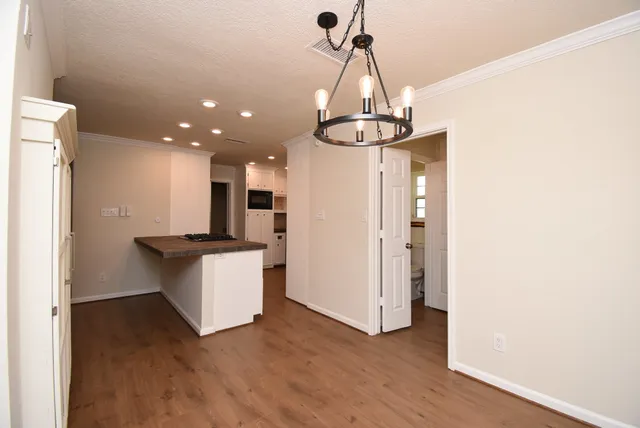 a kitchen with granite countertop white cabinets and a sink