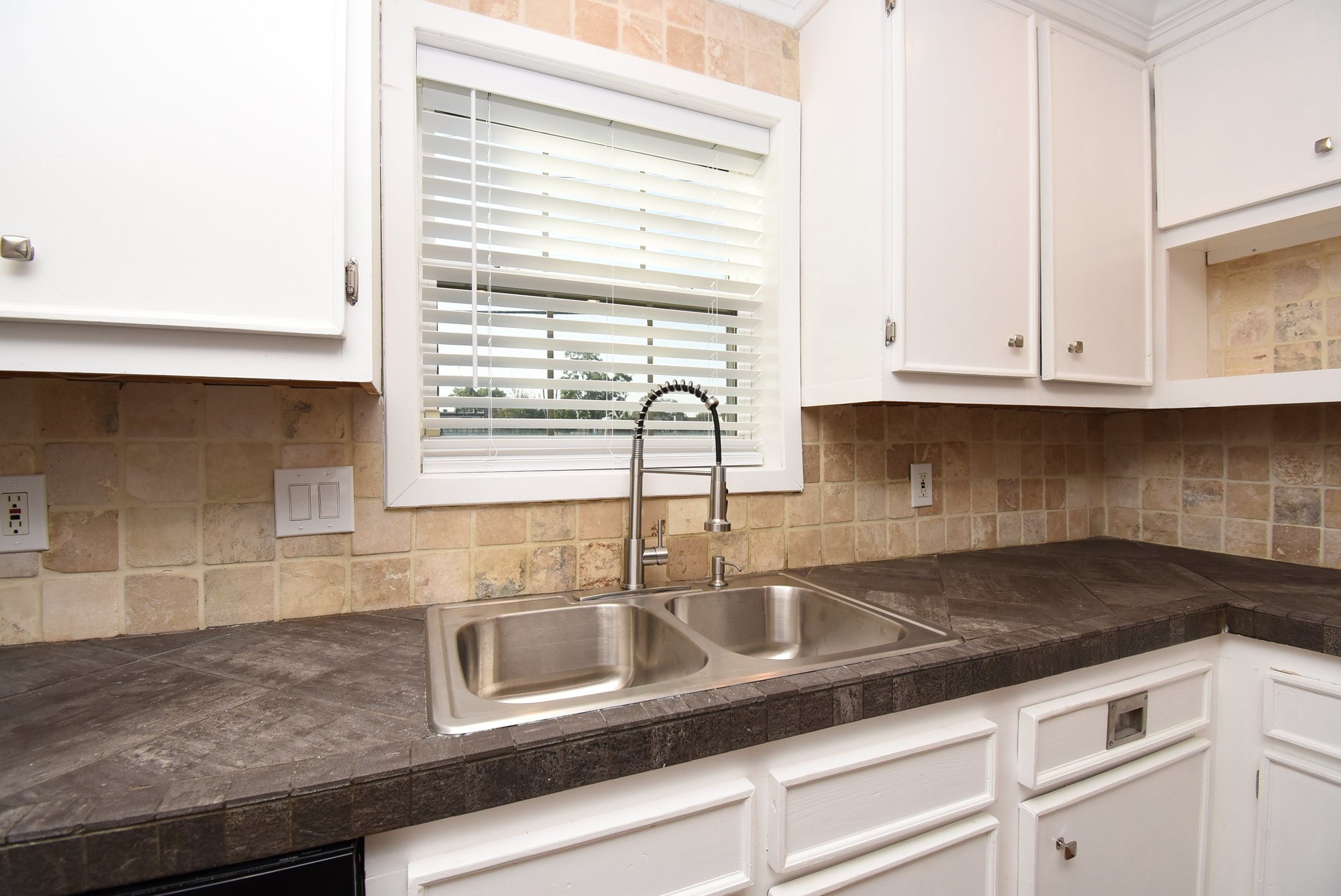 2503 Southwick Street Houston, TX 77080 - Photo 15 of 46 a kitchen with granite countertop white cabinets and a sink