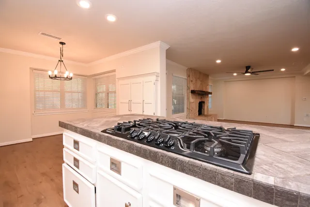 a kitchen with granite countertop white cabinets and white appliances