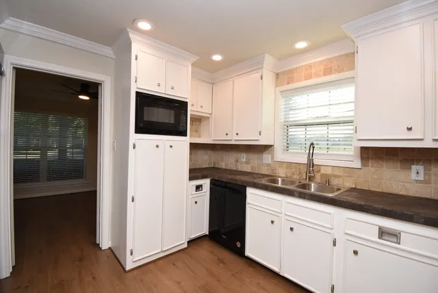 a kitchen with a sink and a mirror