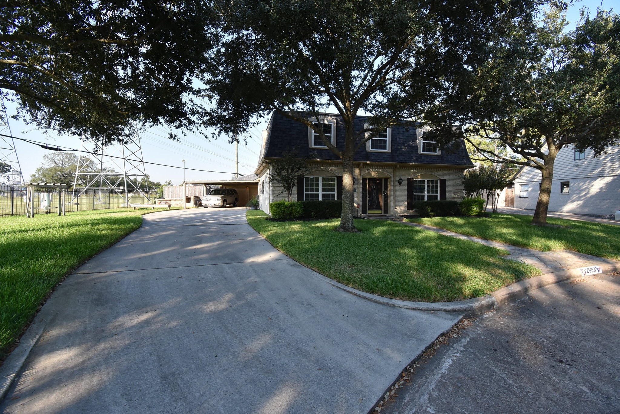 2503 Southwick Street Houston, TX 77080 - Photo 3 of 46 a front view of a house with a garden and trees