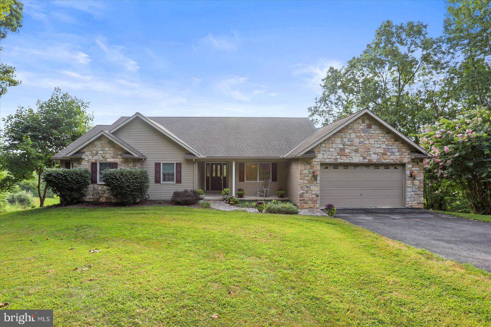 a front view of house with yard and green space