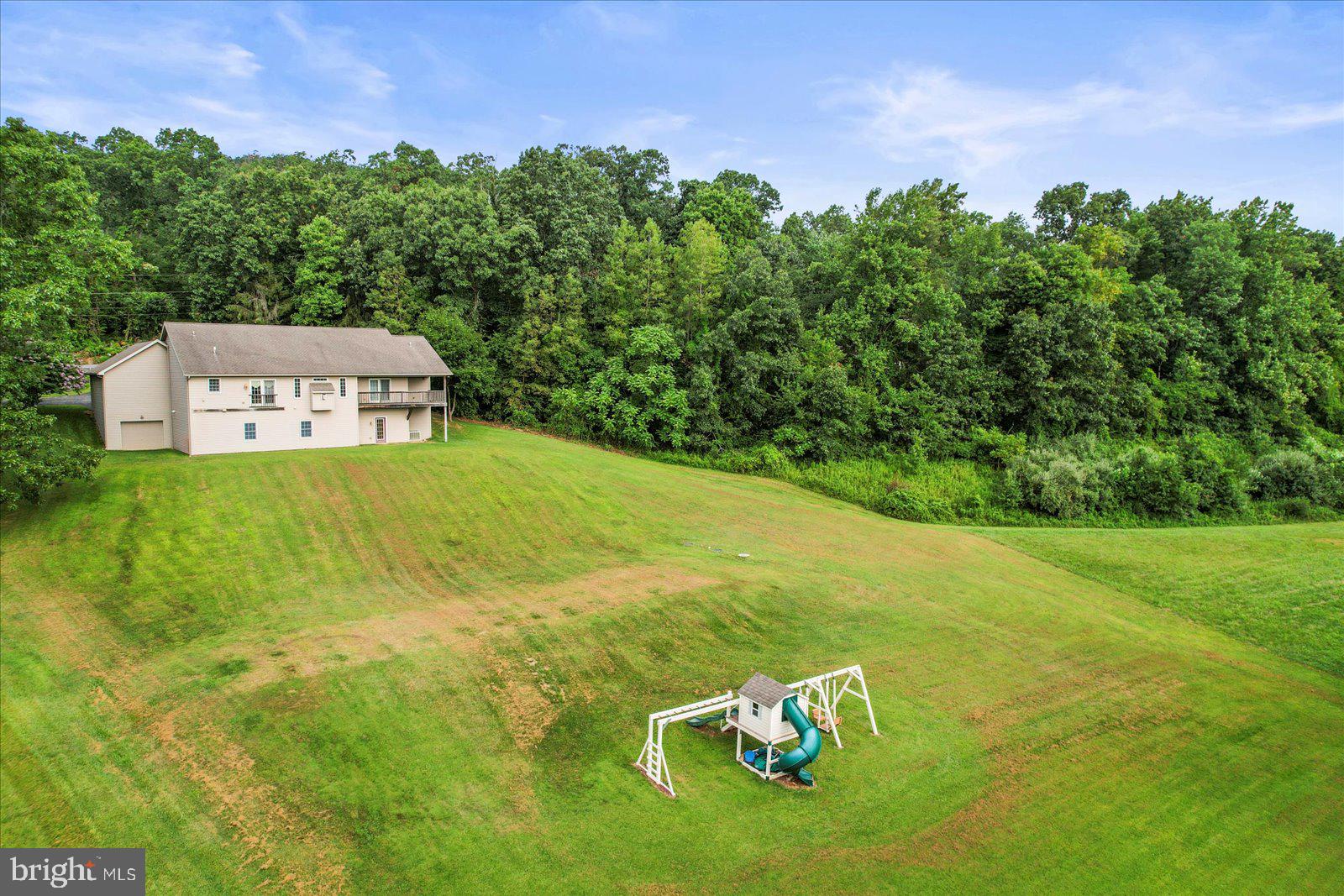 115 Packing House Road Hanover, PA 17331 - Photo 7 of 59 a view of a big yard with an outdoor space and seating area