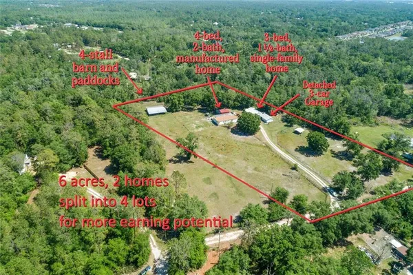 an aerial view of a multi story residential apartment building with a yard and flowers