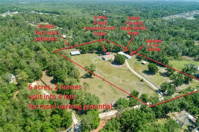 an aerial view of a multi story residential apartment building with a yard and flowers