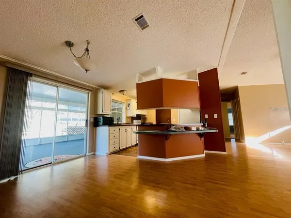 a kitchen with stainless steel appliances a stove top oven a sink and a refrigerator