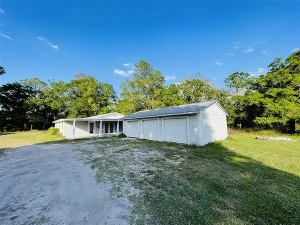 a view of an house with backyard space and garden