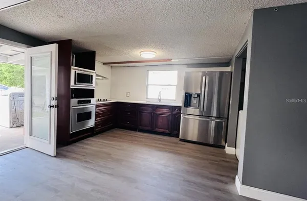 a kitchen with stainless steel appliances a refrigerator and a stove top oven