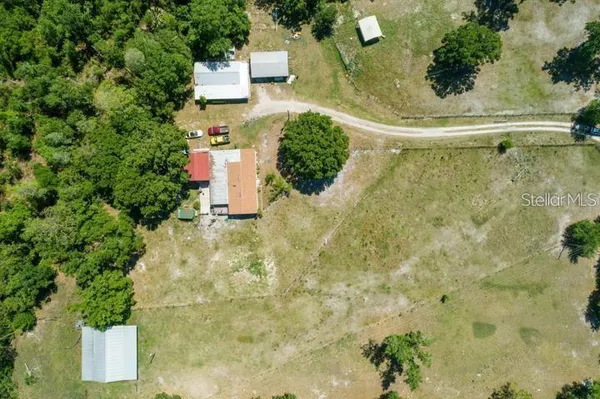 an aerial view of a house with a yard