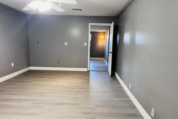 a view of a room with wooden floor