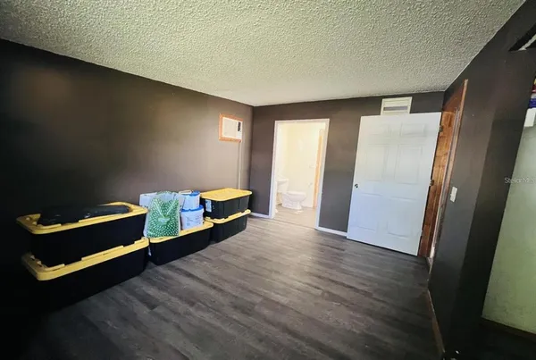 a hallway with a bed and wooden floor