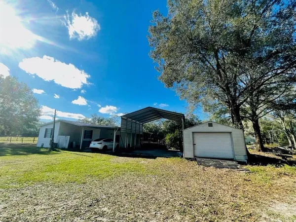 a front view of a house with a yard and a garage
