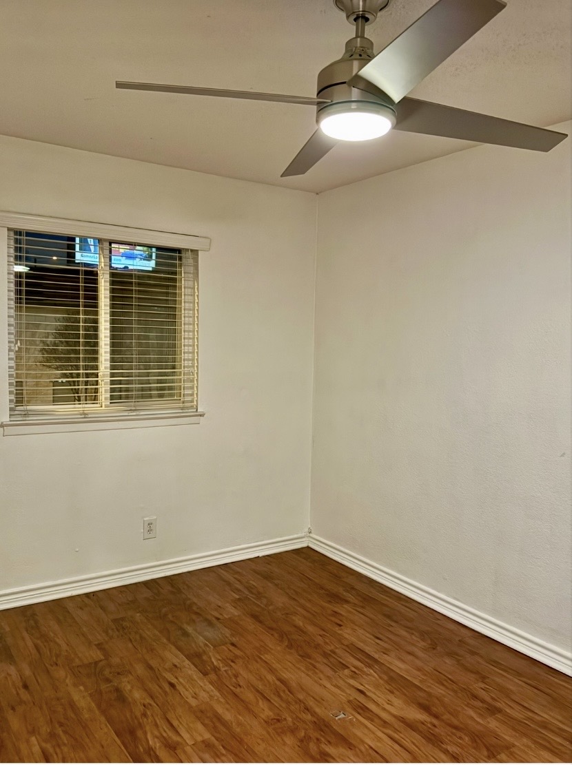 2401 Manor Road, Unit 120 Austin, TX 78722 - Photo 13 of 34 a view of an empty room with wooden floor and a window