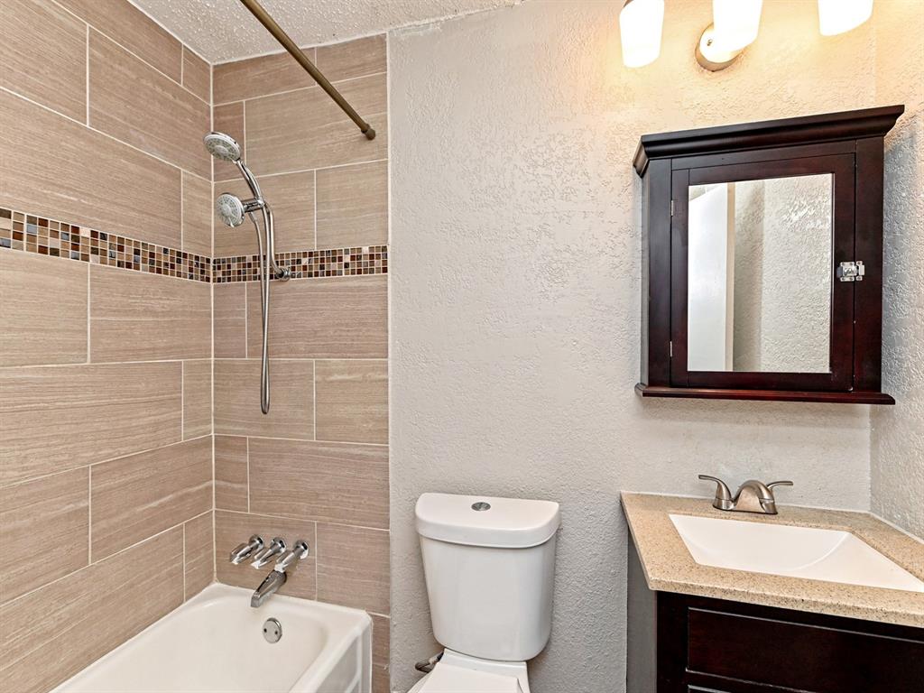 2401 Manor Road, Unit 120 Austin, TX 78722 - Photo 24 of 34 a bathroom with a sink toilet and mirror