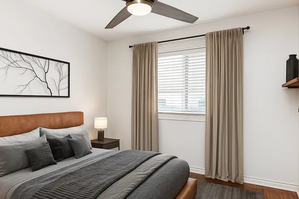 a bedroom with a large bed and a window