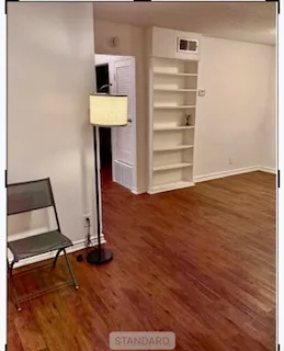 a view of room with wooden floor and chair