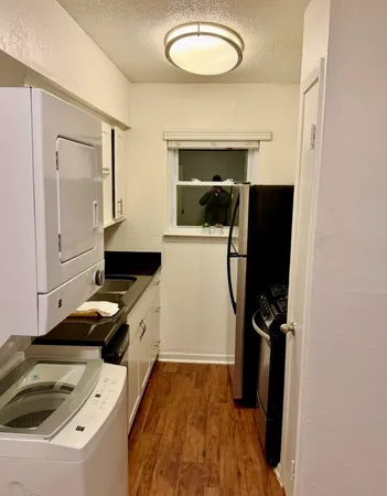 a kitchen with a refrigerator and a stove