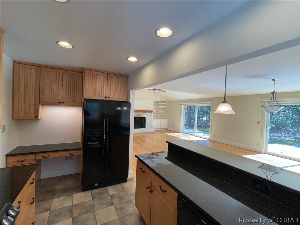 931 Laurel Point Road Lancaster, VA 22503 - Photo 9 of 21 a kitchen with a refrigerator a sink and wooden cabinets