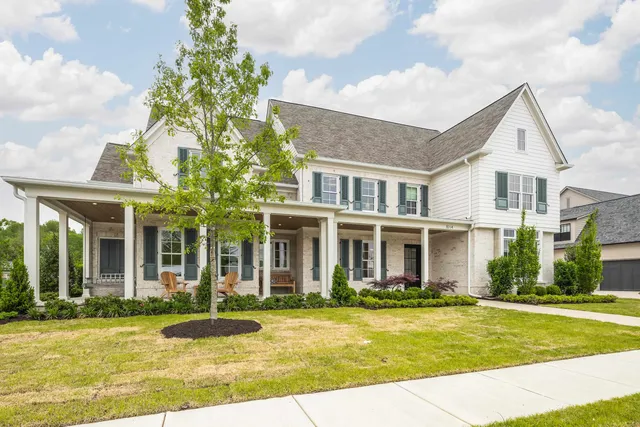 a front view of a house with swimming pool and porch
