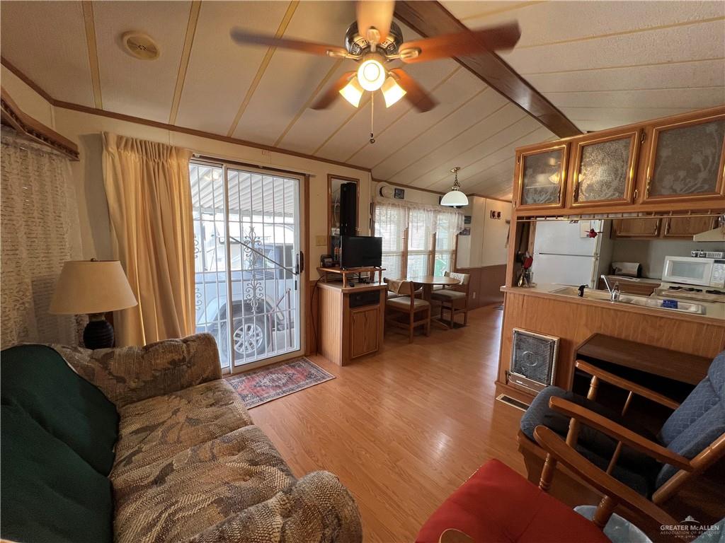 215 South Valley View Road Donna, TX 78537 - Photo 4 of 9 a living room with furniture a flat screen tv and a large window