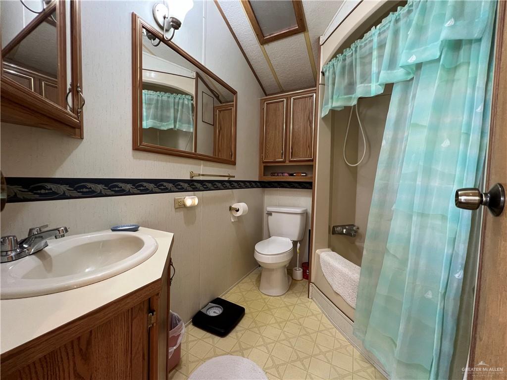 215 South Valley View Road Donna, TX 78537 - Photo 6 of 9 a bathroom with a sink toilet and shower