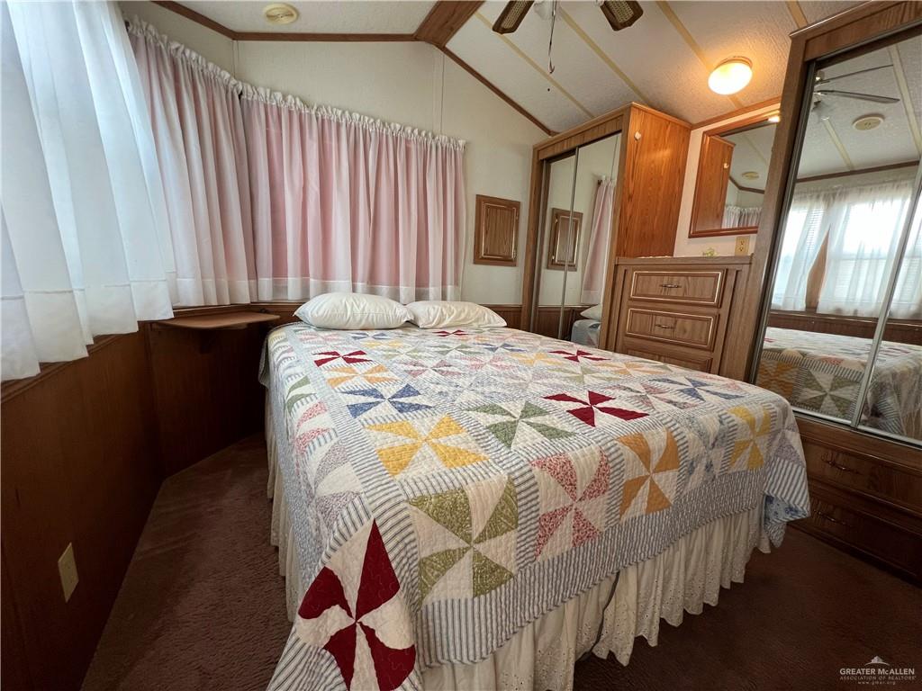 215 South Valley View Road Donna, TX 78537 - Photo 7 of 9 a bedroom with a bed and dresser with mirror