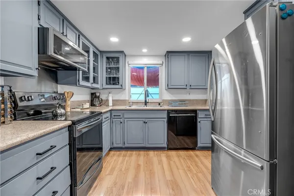 a kitchen with a sink and stainless steel appliances