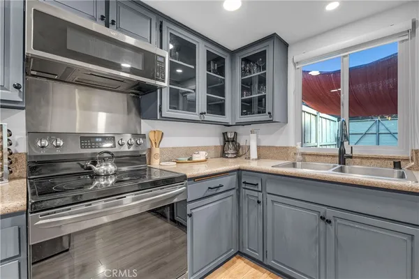a kitchen with furniture and a wooden floor