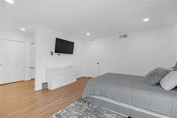 a en suite bathroom with a granite countertop sink a mirror and a shower